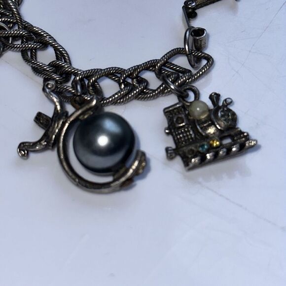 Vintage silver tone charm bracelet featuring modes of travel - Picture 4 of 8